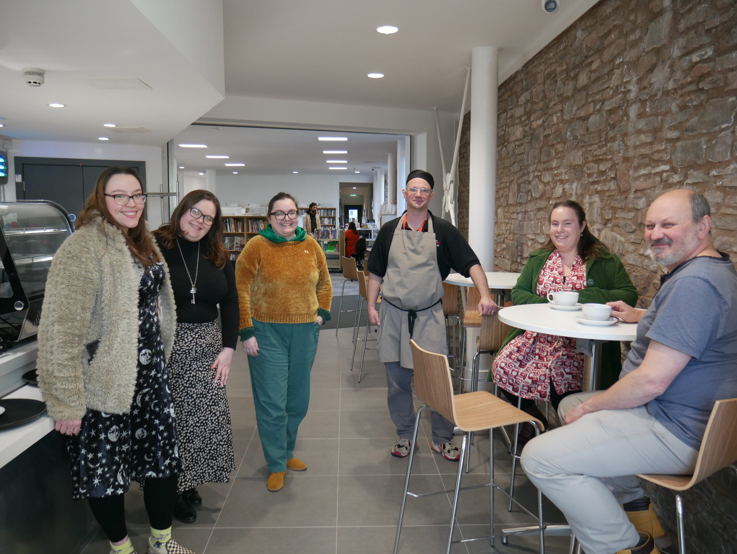 College and y Gaer staff welcome first customers to the Cafe
