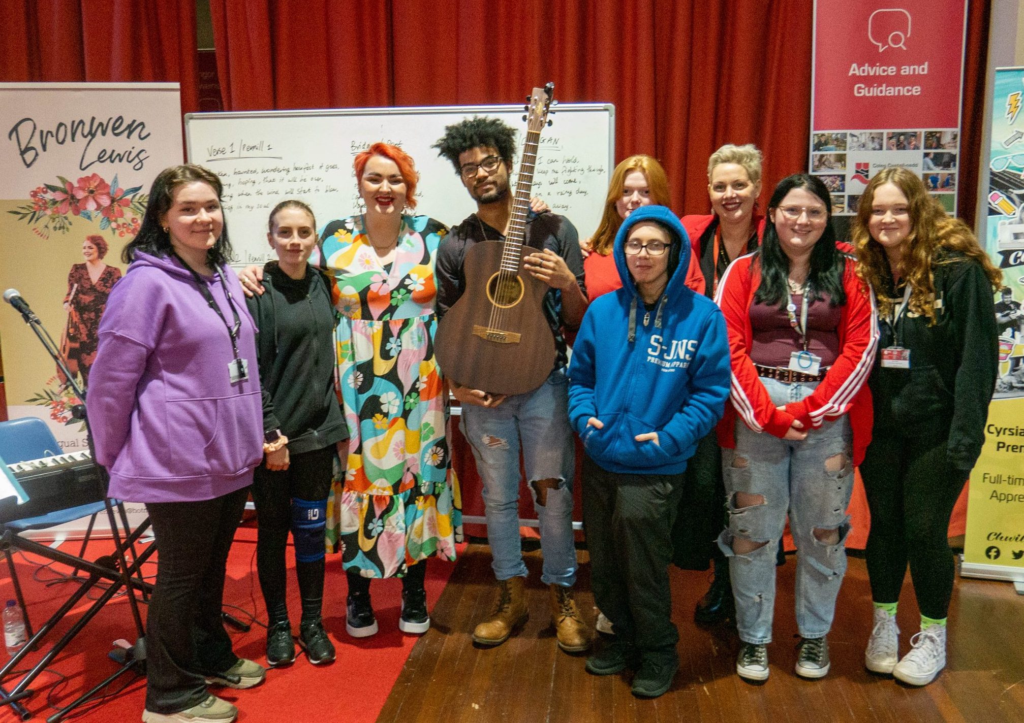 Singer Bronwen Lewis with a group of College students after writing their own song