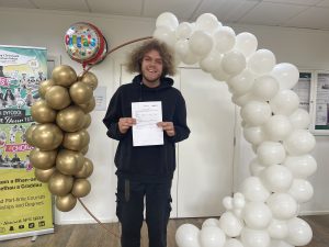 Student Nye with his certifcate and balloons at Netwown College.