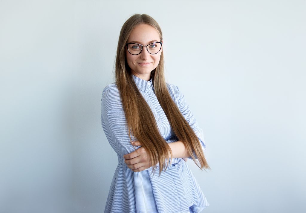 Portrait photo of student Lora Arkhypenko on pale ble background.