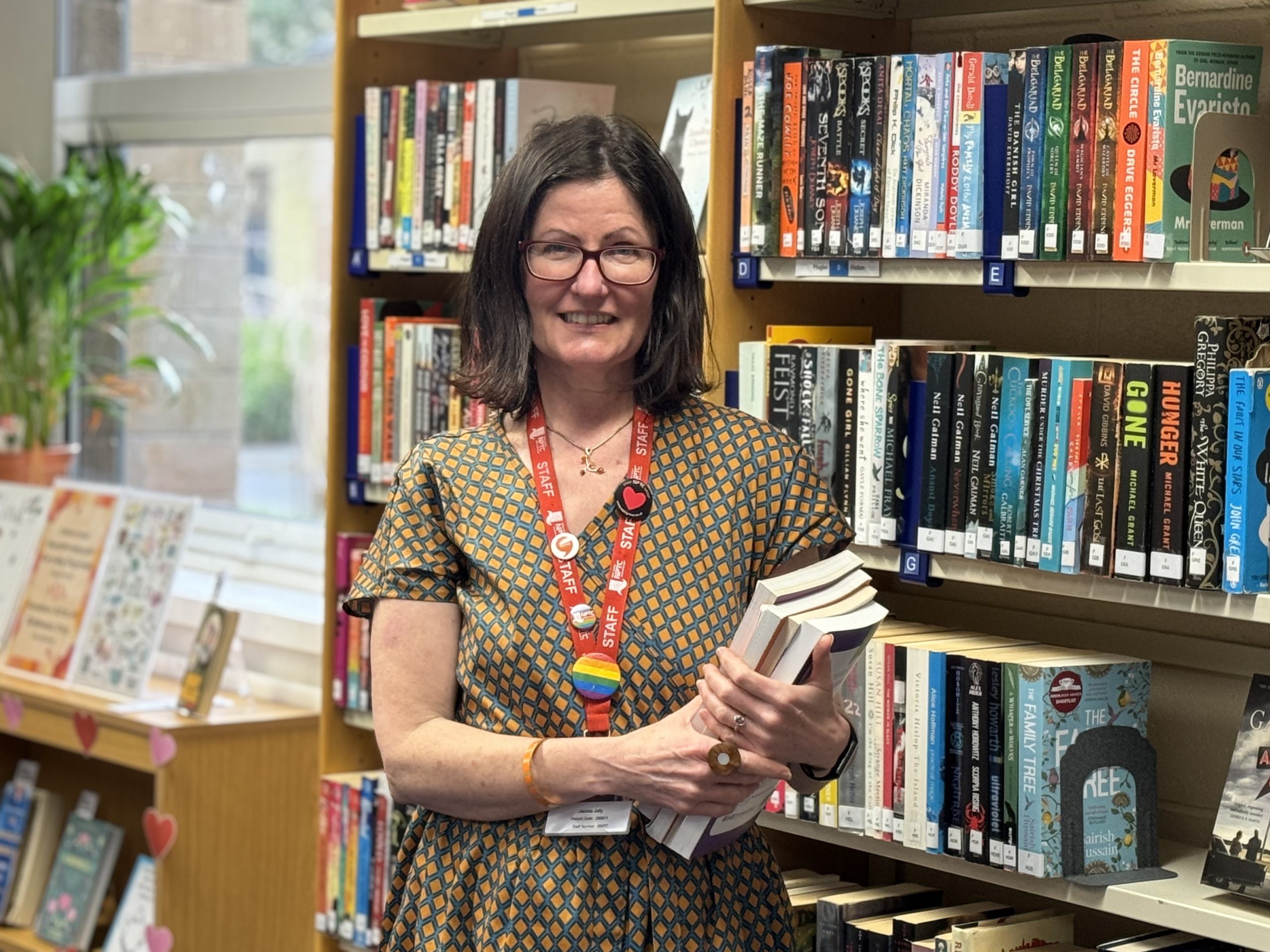 Library staff member Jacinta Jolly holding some books