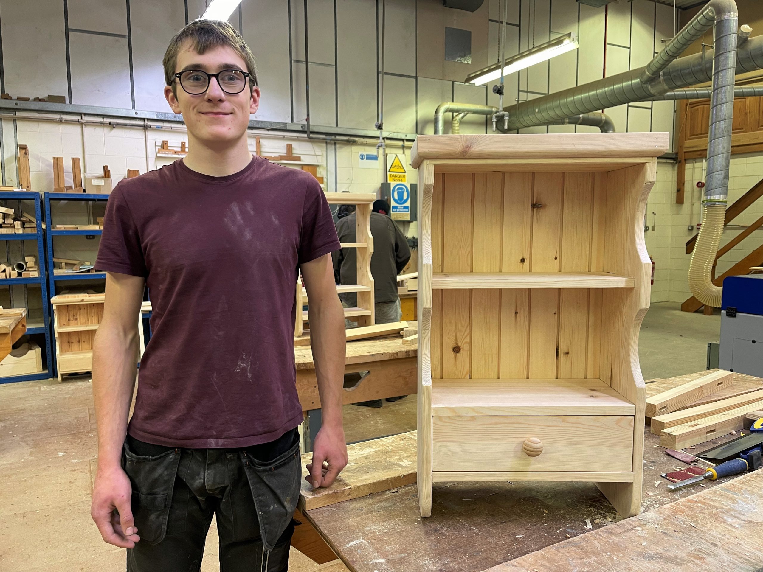 Carpentry student Steve Davies with his handmade wooden cabinet.