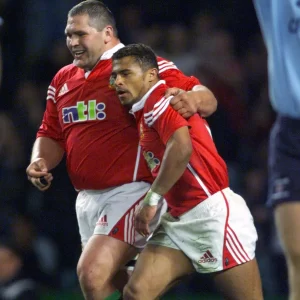 Rugby player Darren Morris in British and Irish Lions kit celebrating with Jason Robinson.